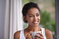 Enjoying the sights and smells of an early morning. a young woman enjoying a cup of coffee. Royalty Free Stock Photo