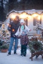 Enjoying spending time together. Family concept. Happy family with sparklers in their hands celebrating Christmas in the winter Royalty Free Stock Photo