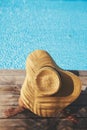 Enjoying summer vacation. Woman in hat relaxing on wooden pier under palm leaves shadow at pool Royalty Free Stock Photo
