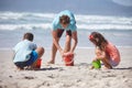 Enjoying the sun, sand and sea. a happy family building sandcastles together at the beach. Royalty Free Stock Photo