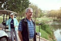 Enjoying a sunny day game. a smiling senior couple enjoying a day on the golf course. Royalty Free Stock Photo