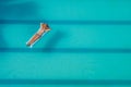 Enjoying suntan. Vacation concept. Top view of slim young woman in bikini on the blue air mattress in the big swimming pool Royalty Free Stock Photo