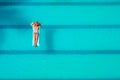 Enjoying suntan. Vacation concept. Top view of slim young woman in bikini on the blue air mattress in the big swimming Royalty Free Stock Photo