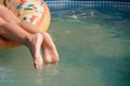 Enjoying suntan. Vacation concept. Top view of slim young woman in bikini on the yellow air mattress in the big swimming Royalty Free Stock Photo