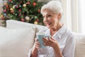 Positive elderly lady is relaxing on couch Royalty Free Stock Photo
