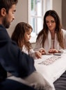 Enjoying their free time as a family. a young family playing cards together at home. Royalty Free Stock Photo