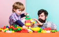 Enjoying time together. building home with colorful constructor. happy family leisure. small boy with dad playing Royalty Free Stock Photo