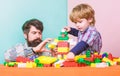 Enjoying time together. building home with colorful constructor. happy family leisure. small boy with dad playing Royalty Free Stock Photo