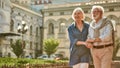 Enjoying time together. Happy and beautiful elderly couple holding hands while walking outdoors Royalty Free Stock Photo