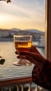 Enjoying Turkish tea, a woman takes in the scenic Bosphorus Bay