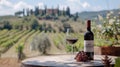 Enjoying Tuscany with a bottle and glass of red wine on a vineyard table Royalty Free Stock Photo