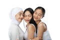 enjoying a veiled girl and two asian young girl hugging with close her eyes Royalty Free Stock Photo