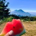 enjoying watermelon on the mountain