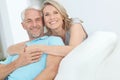 Enjoying the weekend together. Portrait of a happy mature couple relaxing at home. Royalty Free Stock Photo