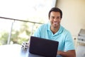 Enjoying wireless freedom. a handsome man contemplating something while sitting with his laptop. Royalty Free Stock Photo