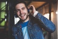 Enjoying work and good music. Cheerful young man in headphones listening to the music Royalty Free Stock Photo