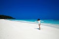 Enjoyment. Carefree happy woman open arms on tropical beach, exotic island. Summer vacation. Brunette girl model resting by sea. Royalty Free Stock Photo