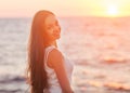 Enjoyment - free happy woman enjoying sunset.