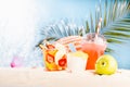 Enjoyment summertime of holiday - picnic and beach games on tropical beach with fruit salad, cold cocktail, sun hat, ice cream. Royalty Free Stock Photo