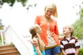 She enjoys spending time with her kids. Two cute young children spending time outdoors with their mother. Royalty Free Stock Photo