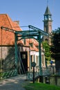 Drawbridge at the entrance of the open-air museum in Enkhuizen with the historic facades and the church in the background