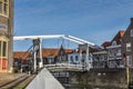 The `Drommedaris`, a traditional drawbridge and the historic gables of Enkhuizen, Holland