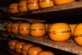 Enkhuizen, Netherlands, June 2022. Close up of a cheese warehouse. The cheeses are stacked on the shelf.