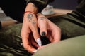 An enlarged photo of the hands of two lesbian girls with the same tattoos.