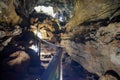 Enlighted lava tunnel with humid floor in the Galapagos island of Sand Cruz on the way to Puerto Ayora, Ecuador