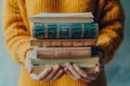 Enlightened Learning: Woman\'s Hands Cradle Pile of Books, Conveying Education, Science, and the Pursuit of Knowledge Royalty Free Stock Photo