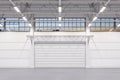 Enlightened White Empty Hangar Interior or Warehouse With Roller Shutter Door and White Concrete Floor. 3d rendering Royalty Free Stock Photo