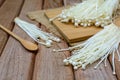 Enoki mushroom with spoon on wooden table Royalty Free Stock Photo