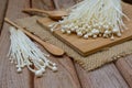 Enoki mushroom with spoon on wooden table Royalty Free Stock Photo