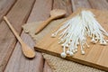 Enoki mushroom with spoon on wooden table Royalty Free Stock Photo