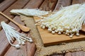 Enoki mushroom with spoon on wooden table Royalty Free Stock Photo