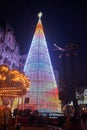Enormous christmas tree in Vigo near a carousel at night Royalty Free Stock Photo