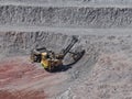 Enormous electric shovel in the process of extracting and loading copper ore from an open-pit mine Royalty Free Stock Photo