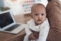 Enough work, when is it playtime. a young woman using a laptop while caring for her adorable baby girl at home. Royalty Free Stock Photo