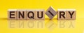 ENQUIRY - word from wooden blocks with letters, sorry concept, yellow background