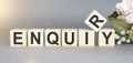 ENQUIRY word written on wood block. ENQUIRY text on table for
