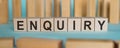 ENQUIRY word written on wooden blocks over light blue background