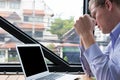 Enraged businessman look at laptop. angry young man holding his