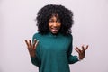 Enraged young curly african woman with hands up yelling isolated on white background