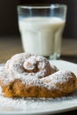 Ensaimada typical of Spain with icing sugar, glass of milk. Selective focus