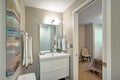 Ensuite bathroom with bathroom vanity and a toilet. Royalty Free Stock Photo