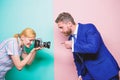 Ensuring that his gesture is sharp and focussed. Businessman posing for female photographer. Fashion photo shoot in Royalty Free Stock Photo