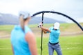 Ensuring she learns the perfect swing. Cropped image of a male coach instructing his female student using a ring to Royalty Free Stock Photo