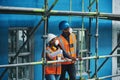 Ensuring the site satisfies the project standards and specifications. a young man and woman working at a construction