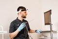 ENT doctor otolaryngologist with endoscope in hands. Prepearing for endoscopy procedure. Doctor with headlight. Royalty Free Stock Photo