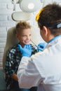 Ent doctor or Otolaryngologist examining a kid nose Royalty Free Stock Photo